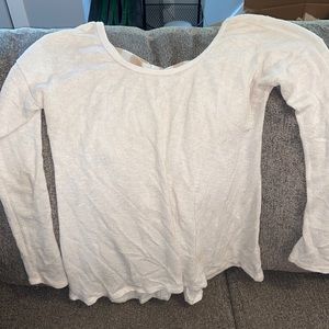 Cream colored sweater with bow tie on the back